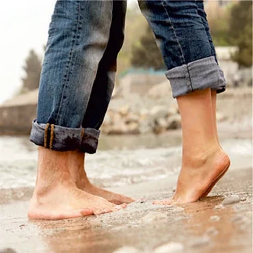Füße von einem Mann und einer Frau im Wasser